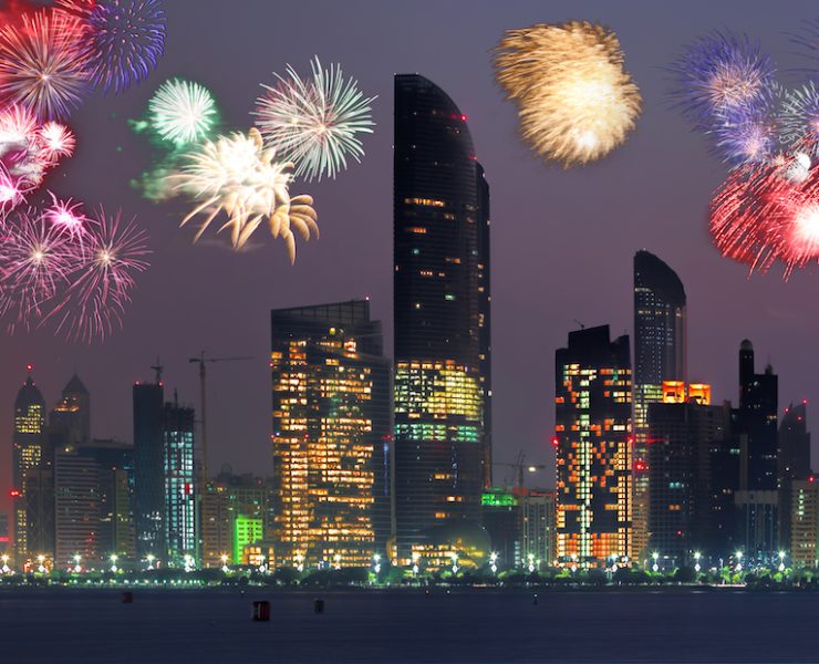 Abu Dhabi with skyscrapers against fireworks in UAE