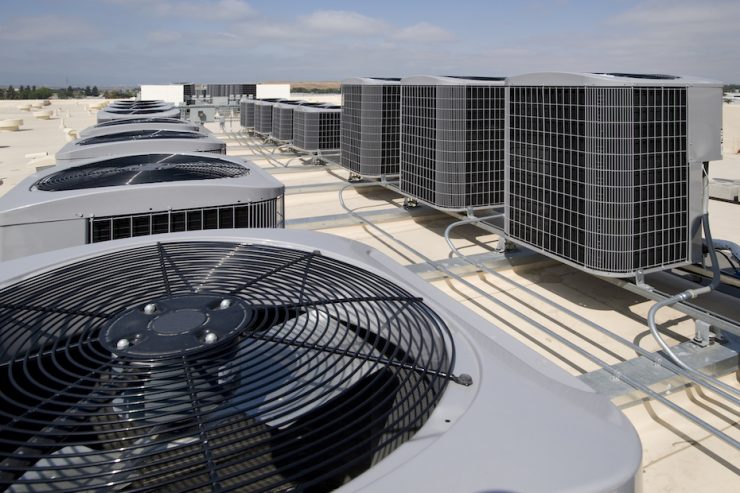 Air conditioning condensers on the roof of a large building. (cooling)