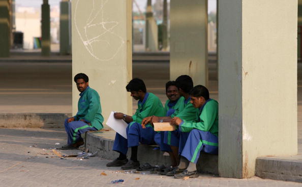 Asian workers take a break at Friday Market in Kuwait City